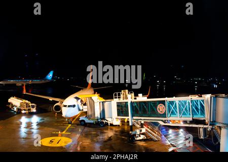 Korean worker people airline ground staff working prepare boeing plane take off flying to sky on runway in night evening time at Jeju International Ai Stock Photo