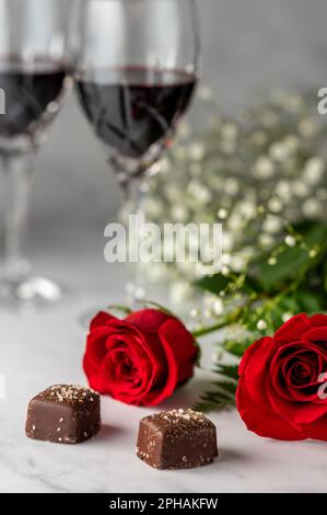 Red roses, dark chocolate and red wine. Above shot. Stock Photo