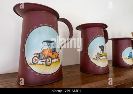 Close-up of a set of three antique measuring cans with tole painted designs, Bucks County, Pennsylvania, USA Stock Photo