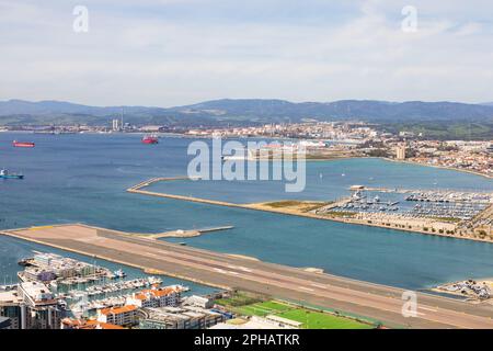 Gibraltar airport runway extending into the sea. The British Overseas Territory of Gibraltar, the Rock of Gibraltar on the Iberian Peninsula. Stock Photo