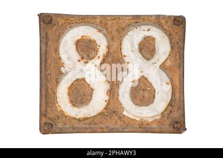 Old retro weathered cast iron plate with number 88 closeup isolated on white background Stock Photo