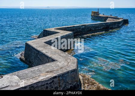 The Blocks, the Zig Zag breakwater to protect the harbour from the force of the waves at St Monans in East Neuk of Fife, Scotland, UK Stock Photo