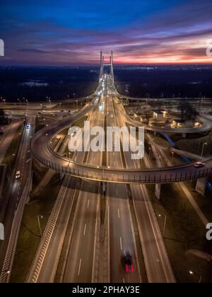 An elevated view of a busy intersection, with multiple cars and cyclists passing through, Warsaw, Poland Stock Photo