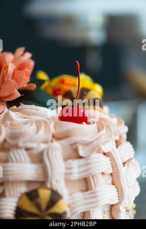 Basket-shaped cake with sweets, cookies and flowers,Easter marks the end of Holy Week, known in the United States as Spring Break Stock Photo