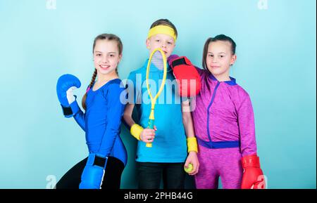 Born to fight. Happy children in boxing gloves with tennis racket and ball. Fitness energy health. punching knockout. Team sport success. workout of Stock Photo