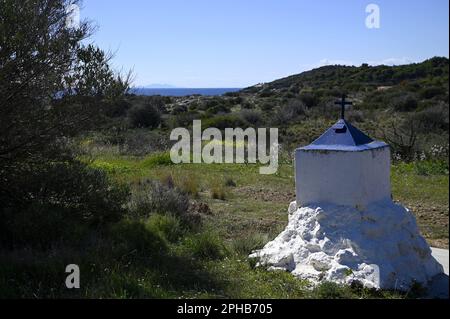 Landscape with scenic view of a blue and white roadside memorial shrine in the countryside of Sounion, Attica Greece. Stock Photo