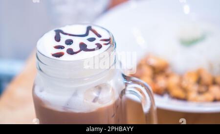 cute cat on top milk foam latte art coffee cup Stock Photo