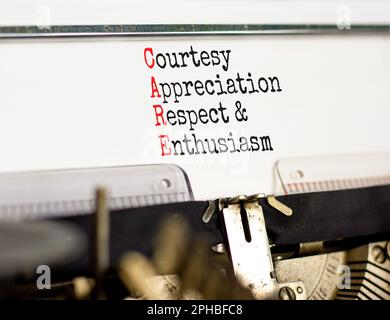 CARE symbol. Concept words CARE courtesy appreciation respect and enthusiasm on typewriter on beautiful white background. Business CARE courtesy appre Stock Photo