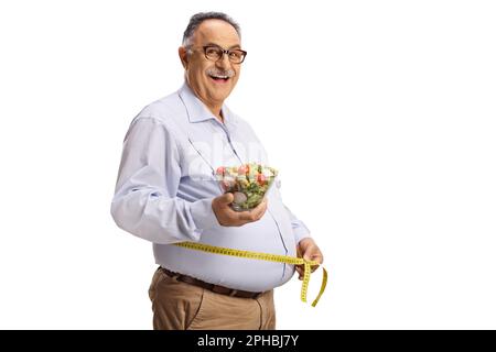 Mature man holding a salad and measuring waist isolated on white background Stock Photo