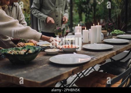 Hand of senior woman preparing dining table for party Stock Photo