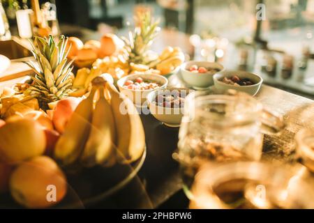 Fresh fruits and healthy breakfast arranged on table at retreat center Stock Photo