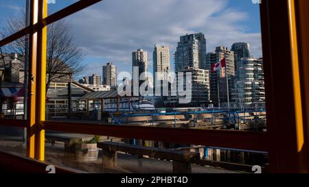 City skyline views from inside Granville Island market of the waterfront and high-rise condominium buildings along False Creek in Vancouver, BC Stock Photo