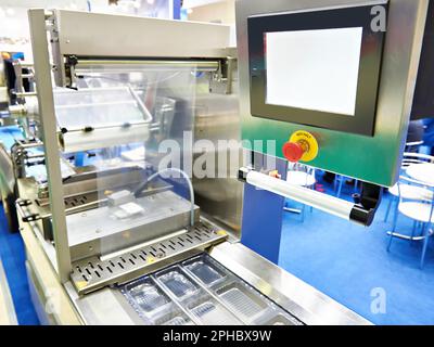 Conveyor at food factory for packing plastic containers Stock Photo