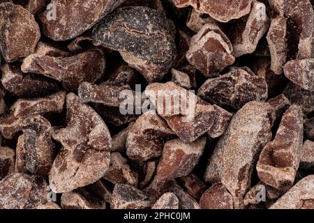 Pieces of broken cocoa beans - also called chocolate nibs, detail under microscope image width 23mm Stock Photo