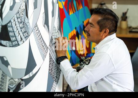 Mexican artist Jacobo Angeles doing a painting in traditional alebrije style, San Martin Tilcajete, Oaxaca, Mexico. Stock Photo