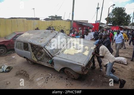 Nairobi, Kenya. 27th Mar, 2023. Protestors overturn a car during a demonstration called by Azimio party leader Raila Odinga over the cost of living and president William Ruto's administration. Credit: SOPA Images Limited/Alamy Live News Stock Photo