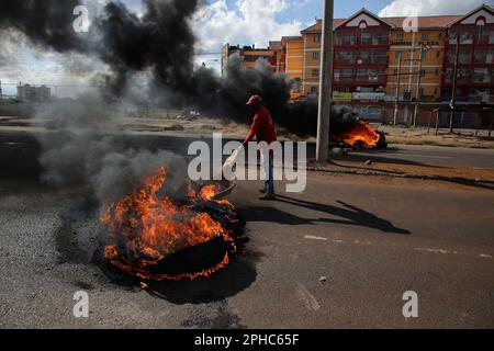 Nairobi, Kenya. 27th Mar, 2023. A protestor lights a box during a demonstration called by Azimio party leader Raila Odinga over the cost of living and president William Ruto's administration. (Photo by John Ochieng/SOPA Images/Sipa USA) Credit: Sipa USA/Alamy Live News Stock Photo