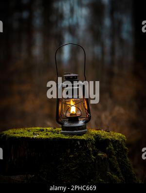 Oil lamp wick lantern made of red glass and metal isolated on