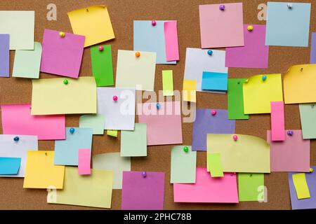 Post blank stickers on cork bulletin board. Concept of business notes. Stock Photo