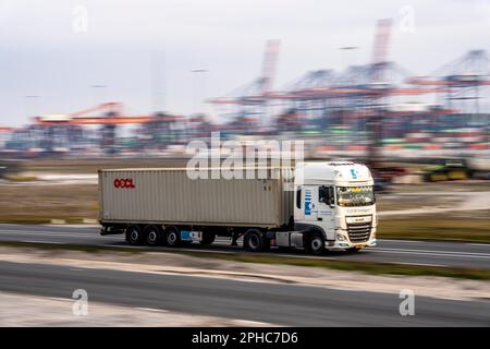 Container truck, bringing containers from Euromax Container Terminal, the seaport of Rotterdam, the Netherlands, deep sea port Maasvlakte 2, on a man- Stock Photo