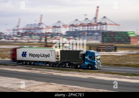 Container truck, bringing containers from Euromax Container Terminal, the seaport of Rotterdam, the Netherlands, deep sea port Maasvlakte 2, on a man- Stock Photo