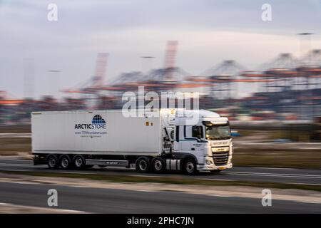 Container truck, bringing containers from Euromax Container Terminal, the seaport of Rotterdam, the Netherlands, deep sea port Maasvlakte 2, on a man- Stock Photo