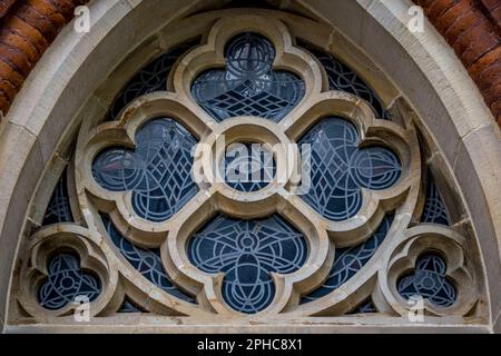 Gothic-style rose window of St. Johann Kirche in Bremen Schnoorviertel with an all-seeing eye at its center and a peace dove below. Stock Photo