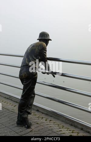 Statue of a fisherman on the pier in Baku Stock Photo