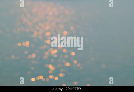 Defocused water during Morning sun light reflection on the water look glittery and shines. To for background. Stock Photo