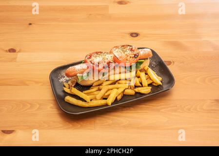 The hot dog is a food in the form of a sandwich with the combination of a frankfurt or Viennese sausage, boiled or fried, served in an elongated bun t Stock Photo