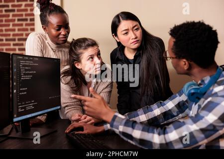 Diverse software developers programming application, typing html code on computer. Cyber security company enginners encrypting cloud processing data system using blockchain technology. Stock Photo