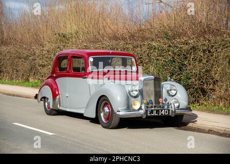 1952 Alvis TA21 saloon parked on a country road in front of a tall hedge on a sunny Winter day Stock Photo