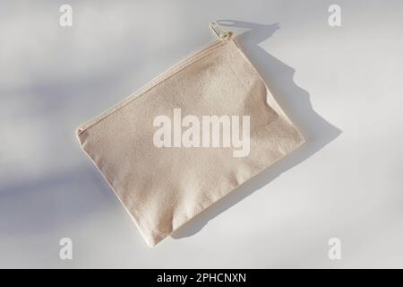 Canvas cosmetic bag mock-up in natural light on the white table Stock Photo