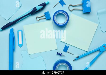 Composition with drawing compass, scotch tape and sticky notes on blue background Stock Photo