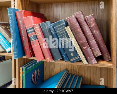 Vintage old medical textbooks and science books on a bookshelf in a antique store or flea market in Montgomery Alabama, USA. Stock Photo