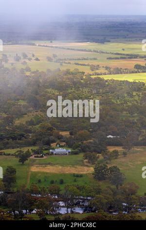 Misty view of Mt Sturgeon station from the slopes of Mt Sturgeon Stock Photo