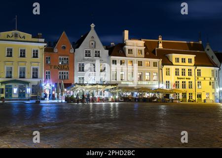 Tallinn Town Square at Tallinn, Estonia. Main square of Tallin with old buildings with restaurants at night. Stock Photo