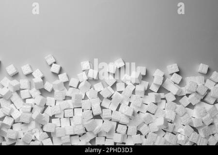 Many styrofoam cubes on grey background, flat lay. Space for text Stock Photo