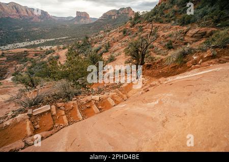 High angle view of woman on Cathedral Rock trail hiking up steps to summit. Stock Photo
