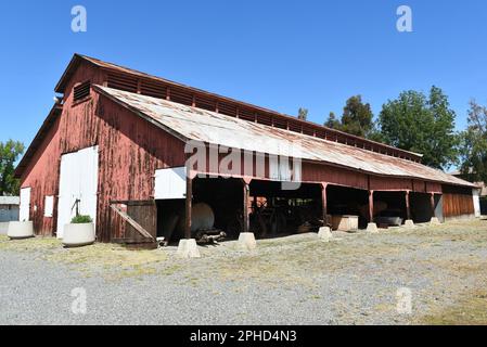 IRVINE, CALIFORNIA - 27 MAR 2023: Driving Barn at the Irvine Ranch Historic Park, former ranch headquarters, now a park featuring vintage agricultural Stock Photo