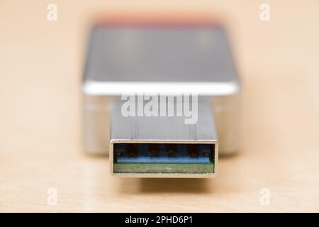 selective focus on the end of a metal USB thumb drive with shallow depth of field Stock Photo