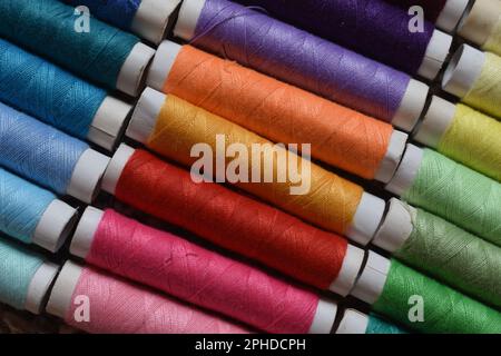 Spools of sewing thread in a variety of vibrant colors. Stock Photo