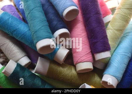 Spools of sewing thread in a variety of vibrant colors. Stock Photo