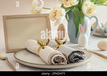 Easter table setting with linen napkins and golden cutlery Stock Photo
