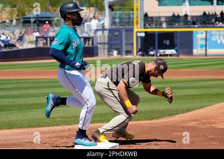 San Diego Padres first baseman Matt Carpenter, right, makes a catch at  first base to get Seattle Mariners' Teoscar Hernandez, left, out during the  second inning of a spring training baseball game