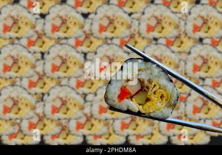 background kimbap or gimbap is Korean roll Gimbap(kimbob) made from steamed white rice (bap) and various other ingredients. Stock Photo