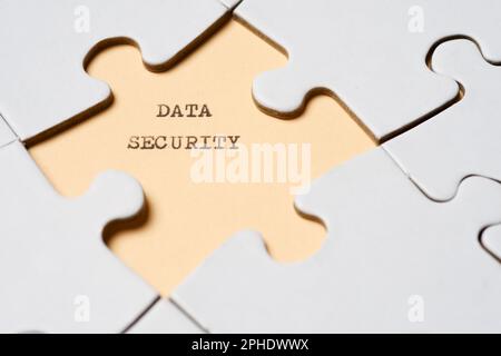 Data security text written with a typewriter in a white puzzle Stock Photo