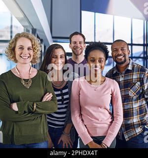 Theyre a team of high-performing experts. Portrait of a team of designers standing together in the office. Stock Photo