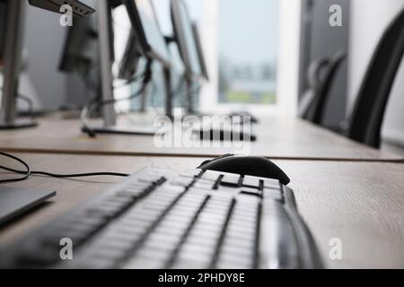 Many modern computers in open space office, focus on keyboard Stock Photo