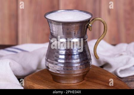 Buttermilk. Sparkling buttermilk in an iron glass. Beverage prepared with yogurt and water. Traditional Turkish delicacies. local name ayran Stock Photo